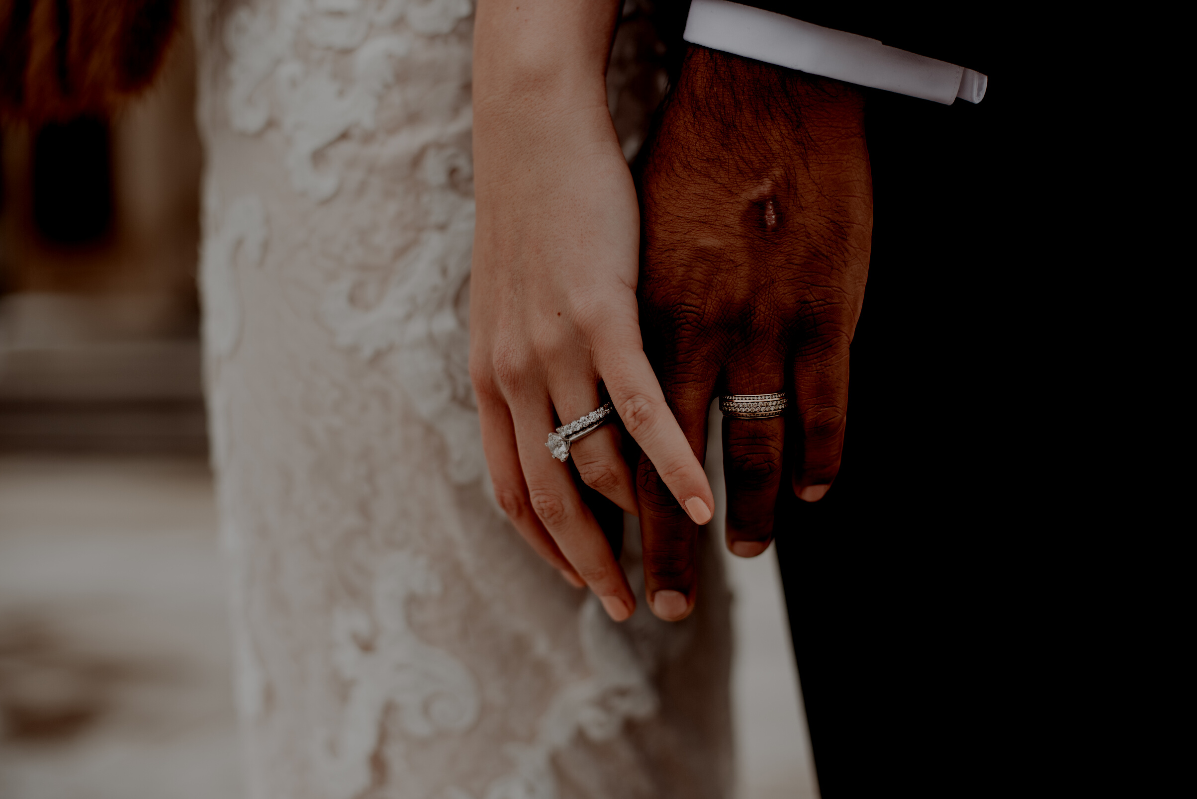 Two Persons Wearing Silver-colored Rings